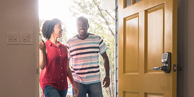 Couple entering their new home.